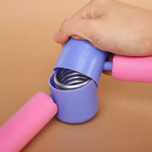 close-up of the durable steel spring hinge mechanism inside a blue plastic casing on a pink thigh exerciser